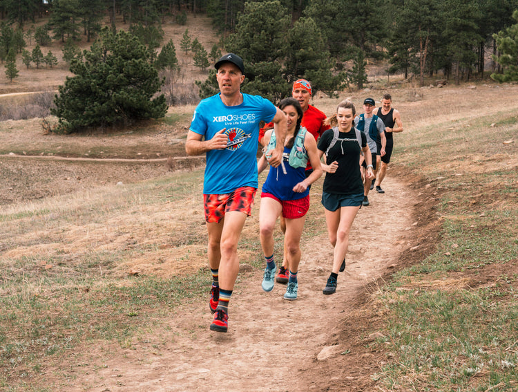 Long distance runners in line running wearing xero shoes