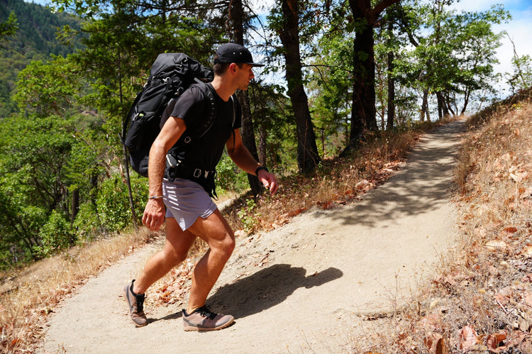 man hiking in xero shoes on dirt path