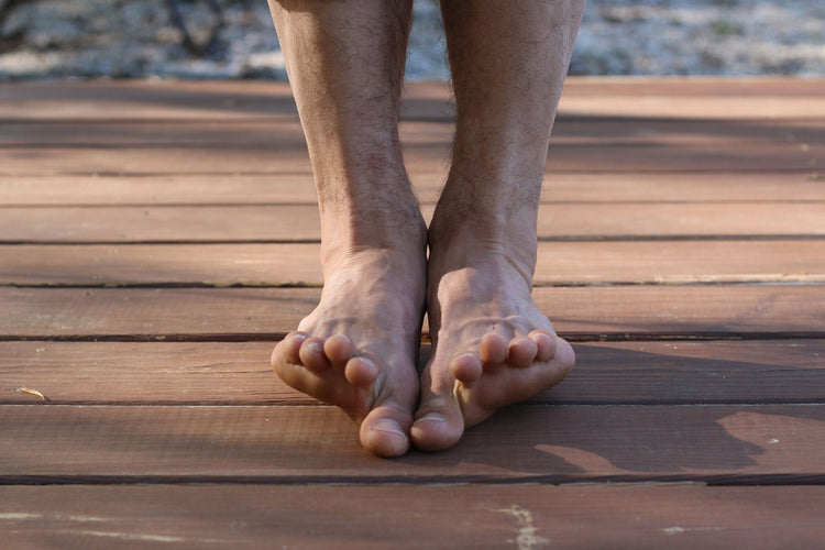 Two bare feet on boards